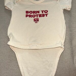 Baby One-Piece Bodysuit "Born to Protest" in Cream with Red Print